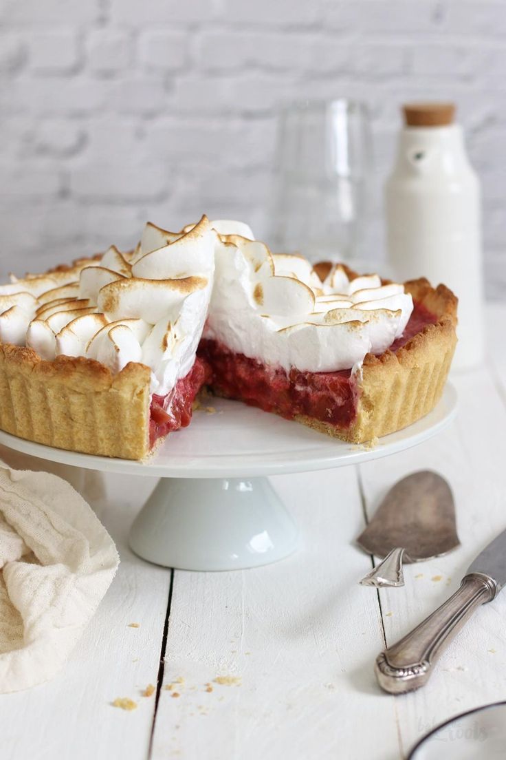 a strawberry pie on a white cake plate