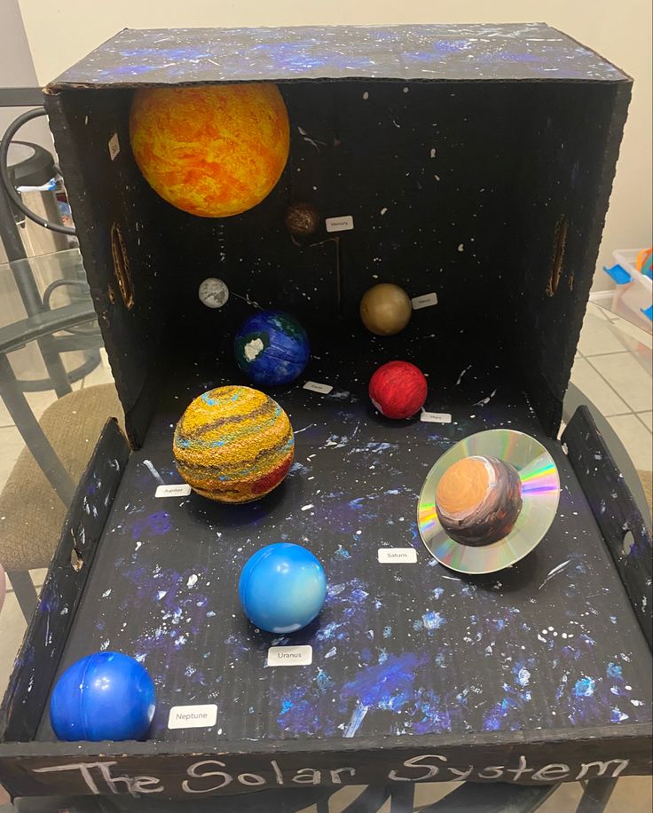 the solar system is on display in an open box with magnets and cd's