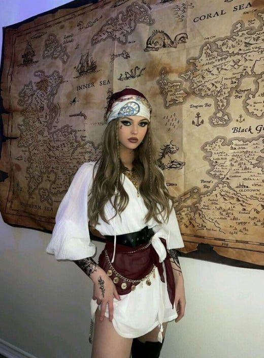 a woman dressed in costume standing next to a map