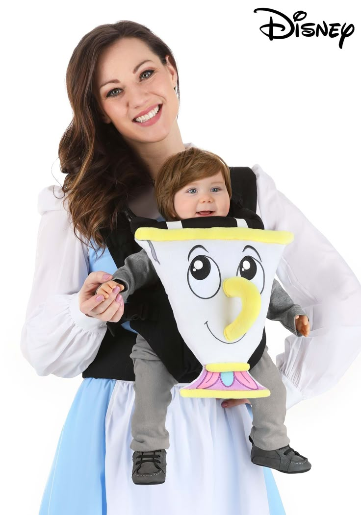 a woman holding a child in a costume