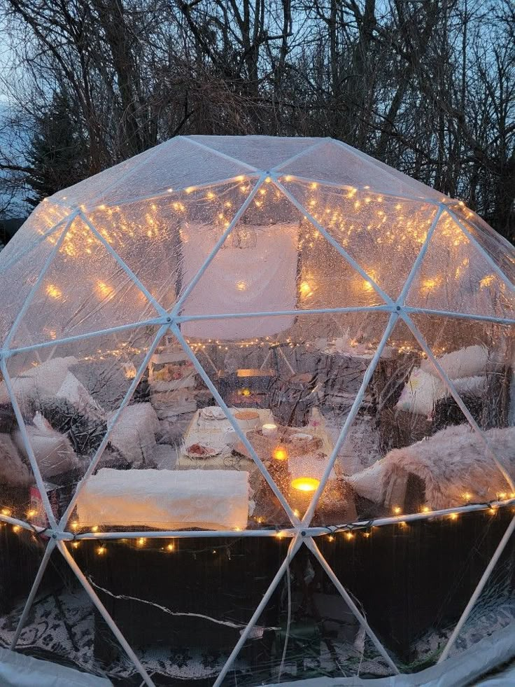 the inside of a dome tent with lights on it