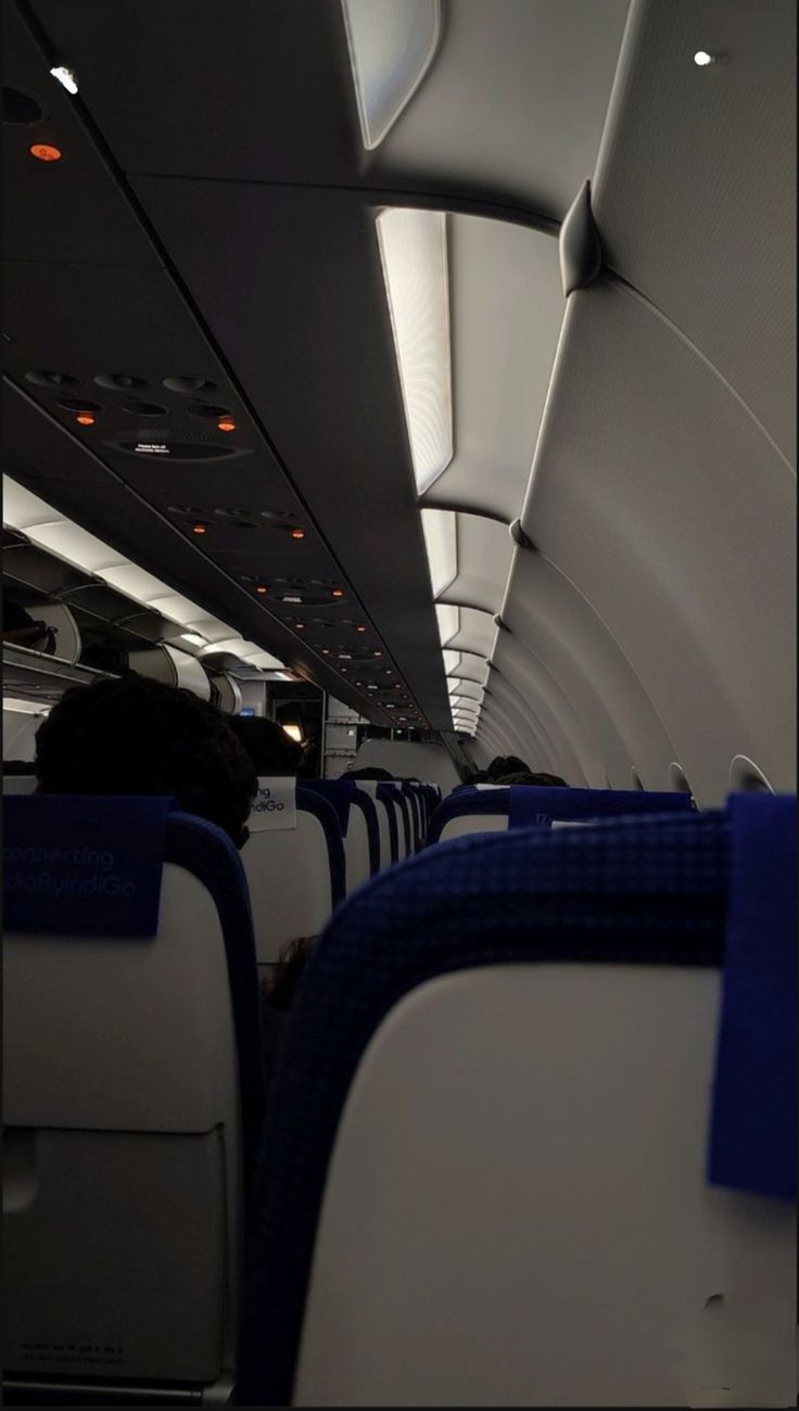 the interior of an airplane with blue and white seats