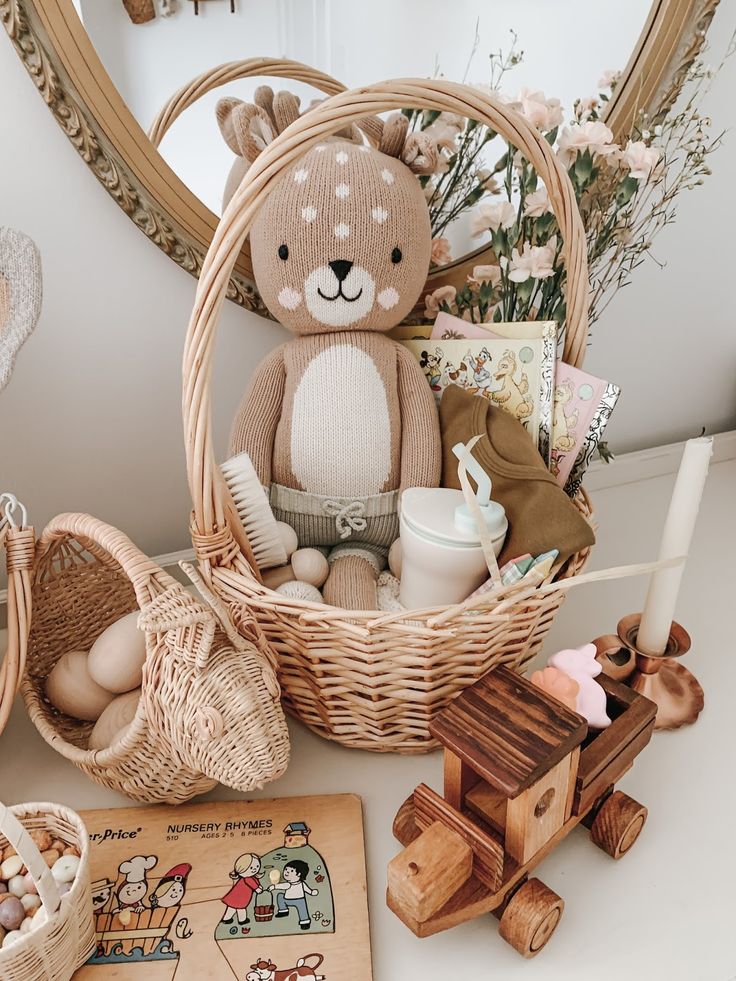 a teddy bear sitting in a wicker basket next to other toys and decor items