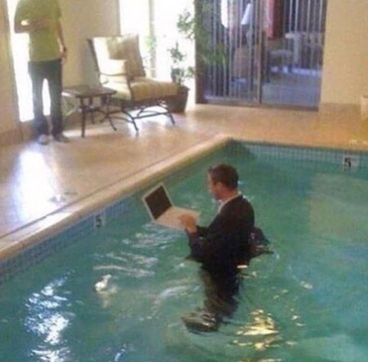 a man is in the pool with his laptop