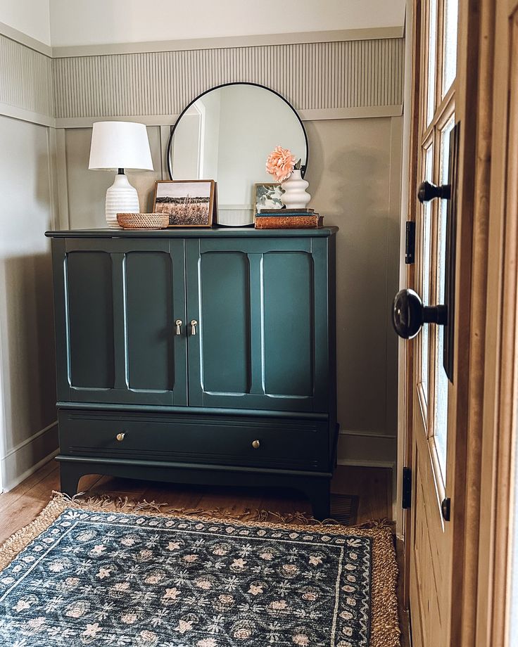 a room with a blue cabinet and rug