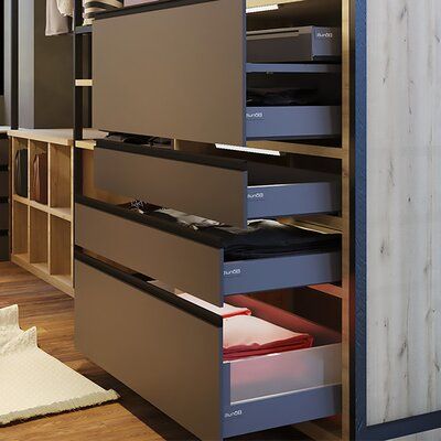 an organized closet with drawers and clothes