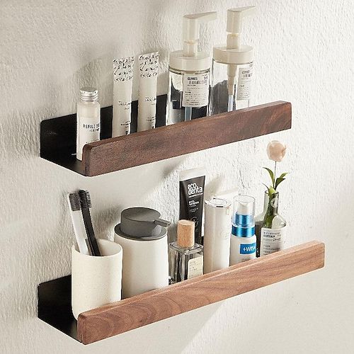 two wooden shelves holding different types of cosmetics and personal care items on them in a bathroom