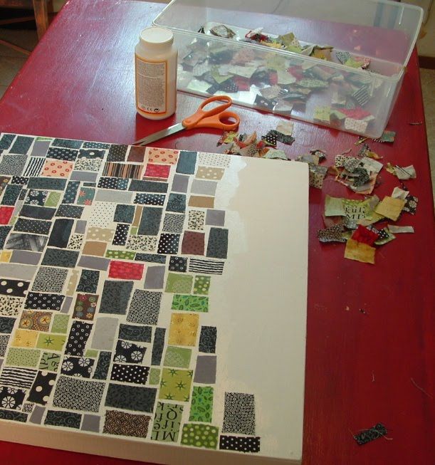 an open book sitting on top of a red table next to scissors and other crafting supplies