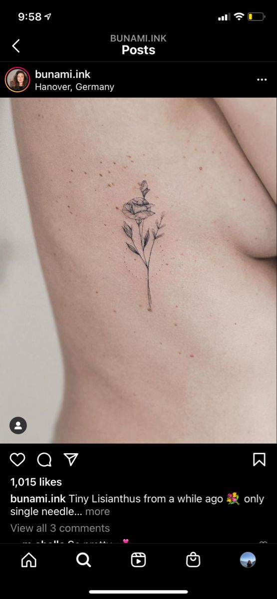 the back of a woman's stomach with a flower tattoo on it