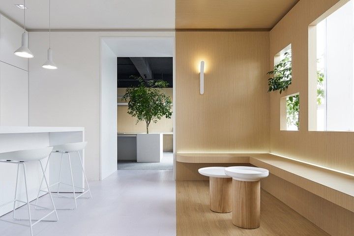 an empty room with stools and plants in the window sill next to each other