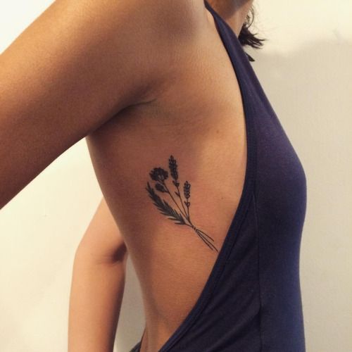 a woman with a flower tattoo on her back