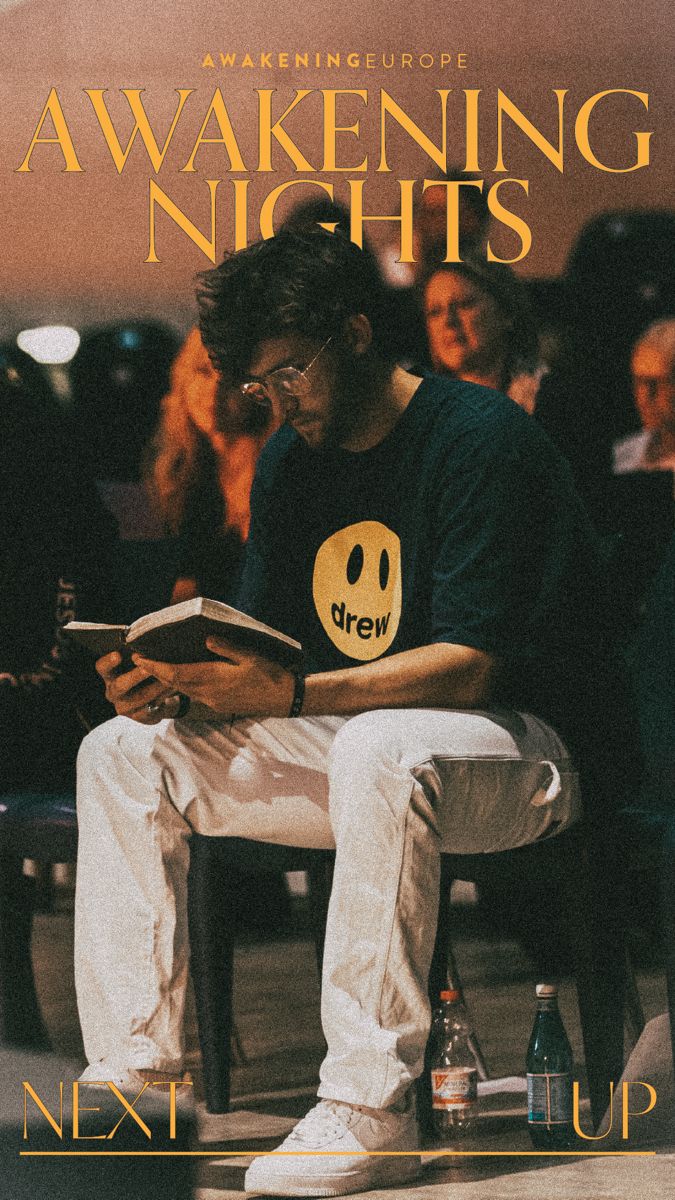 a man sitting in a chair reading a book