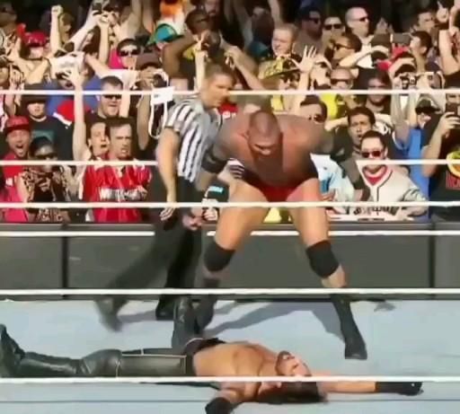 two wrestlers are wrestling in front of an audience