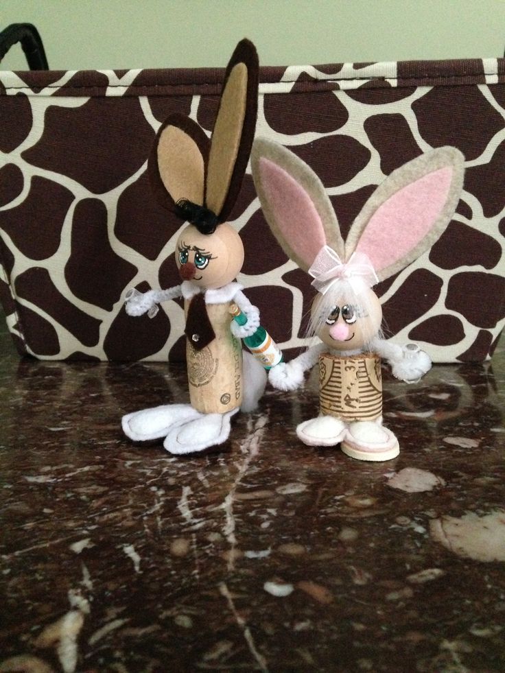 two stuffed animals standing next to each other on top of a brown and white bag