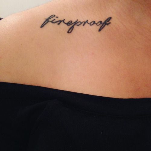 a woman with a tattoo that reads fireproof