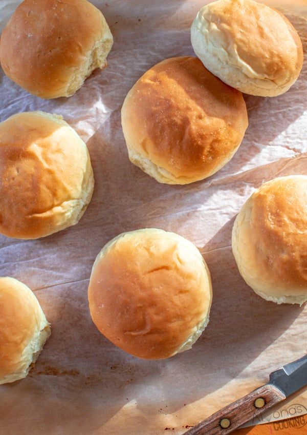 several rolls are sitting on a piece of parchment paper