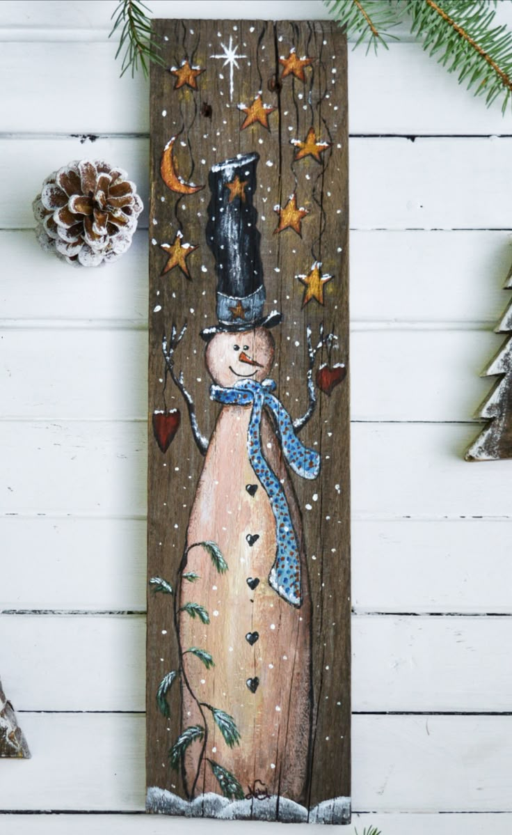 a wooden sign with a snowman wearing a hat and scarf on it's head