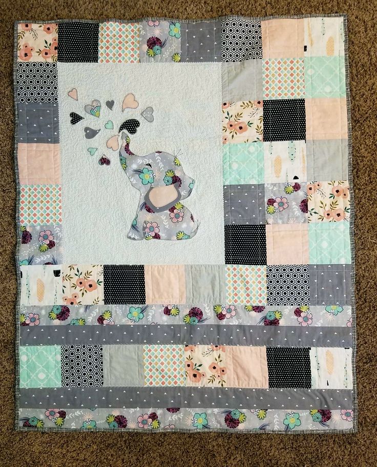 a patchwork quilt with an elephant on it