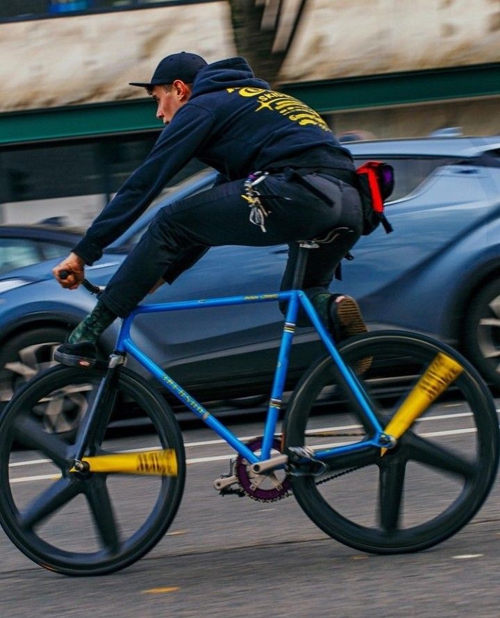 a man riding a bike down the street