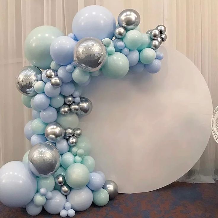 the balloon arch is decorated with silver and blue balloons