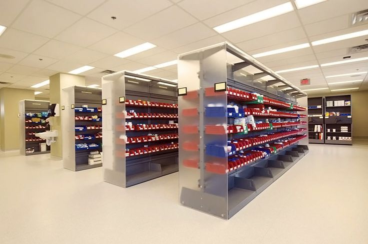 an empty pharmacy room with shelves full of medical supplies