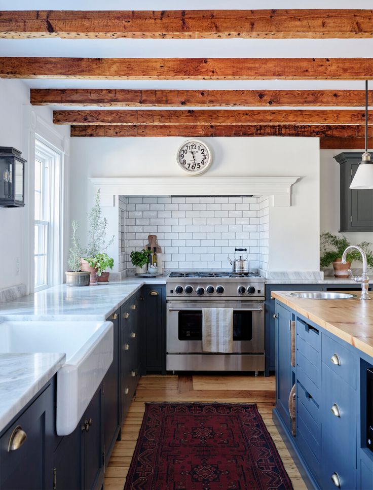 a kitchen with blue cabinets and white counter tops