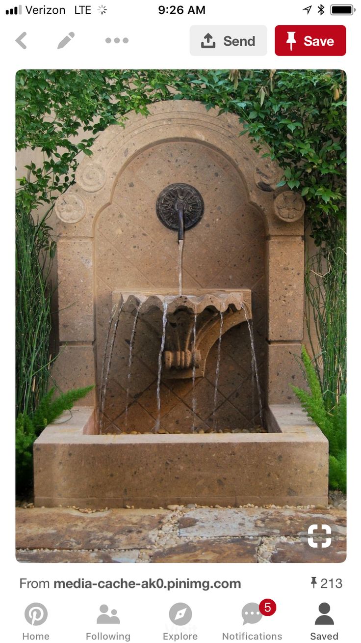 an outdoor fountain with water flowing from it