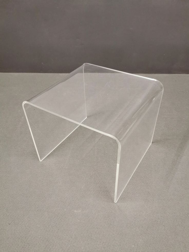 a clear plastic table on a gray surface