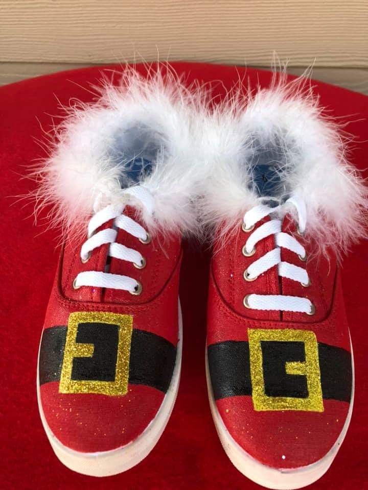 a pair of red shoes with white fur on them sitting on top of a red chair