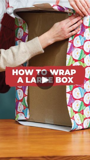 a woman is wrapping a large box with the words how to wrap a large box