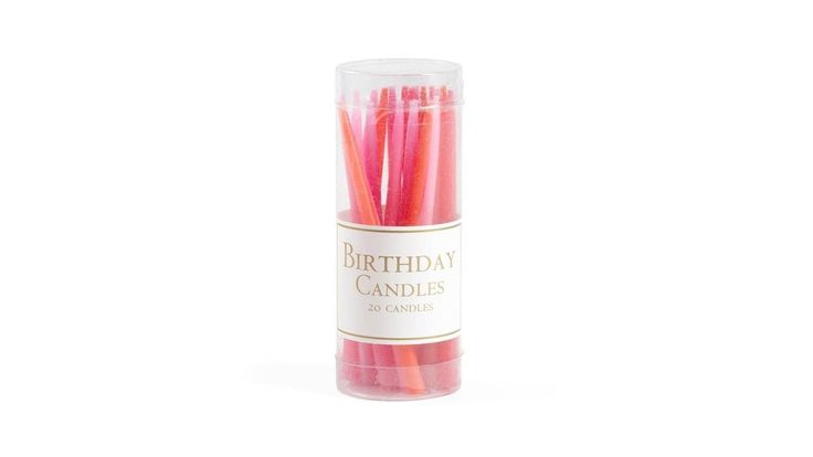 pink birthday candles in a tube on a white background