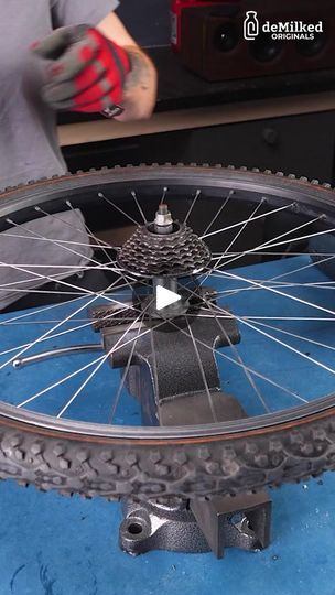 a person is working on a bicycle wheel