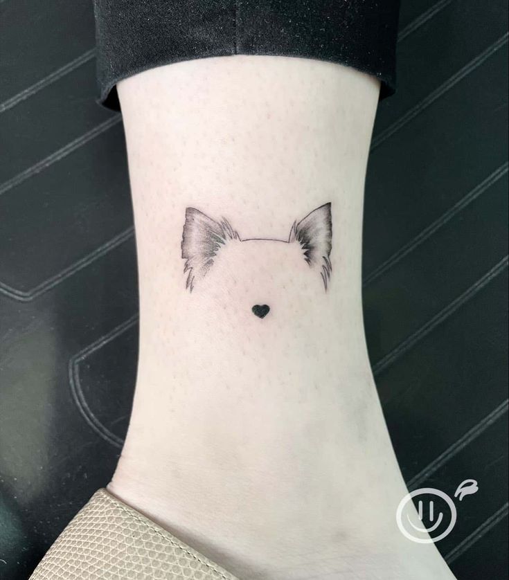 a small dog tattoo on the ankle