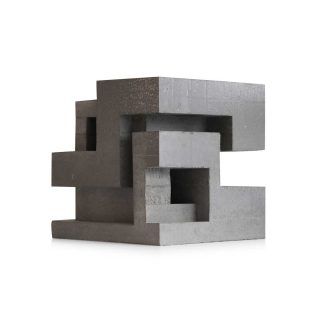 an abstract concrete sculpture on a white background