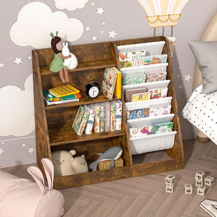 a child's book shelf with toys and books in it next to a bed