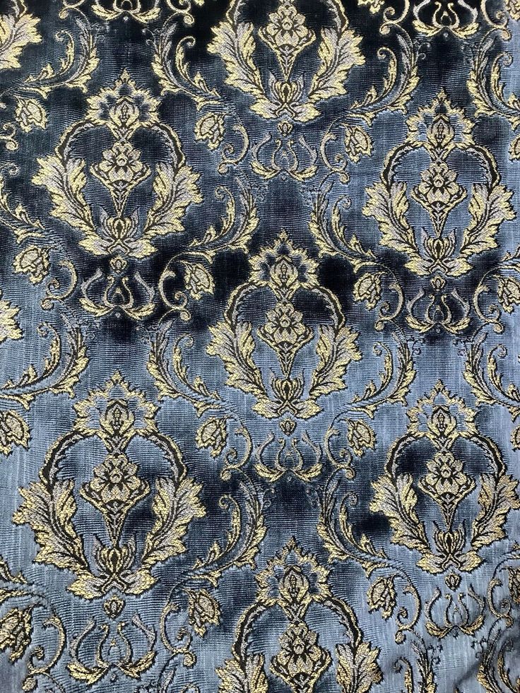 a blue and gold fabric with an ornate design