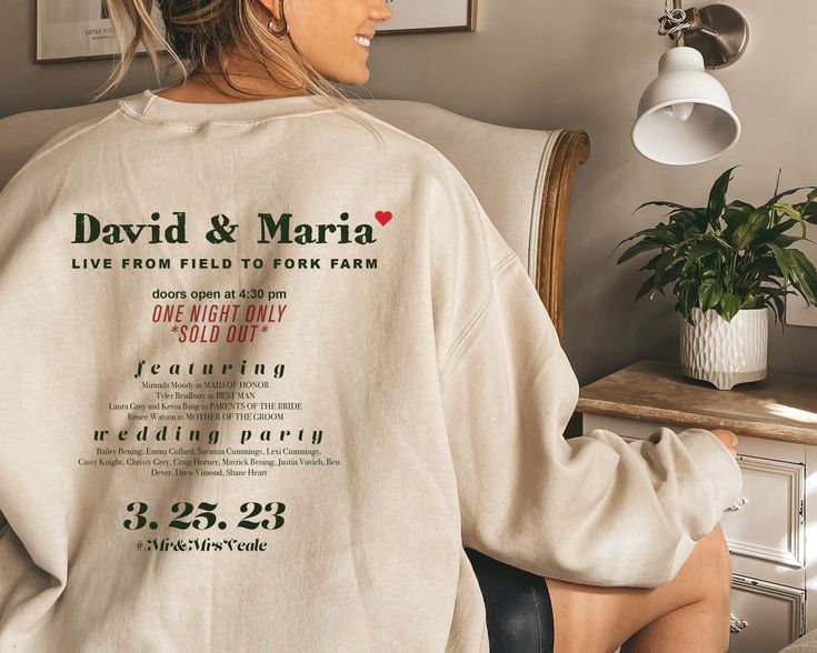 a woman sitting in a chair wearing a sweatshirt with the words david and martha on it