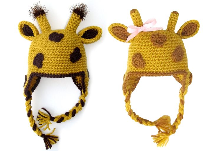 two crocheted hats with giraffes on them, one is yellow and the other is brown