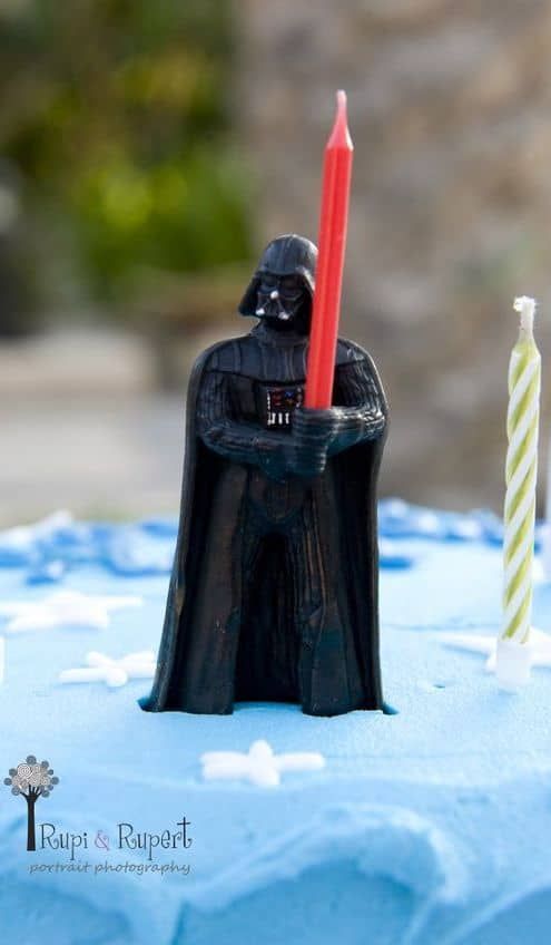 a star wars themed birthday cake with candles in the shape of darth vader