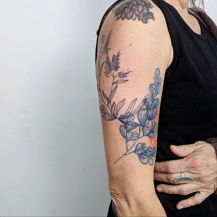 an older woman with a tattoo on her arm