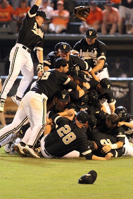 a group of baseball players standing on top of each other in the middle of a pile