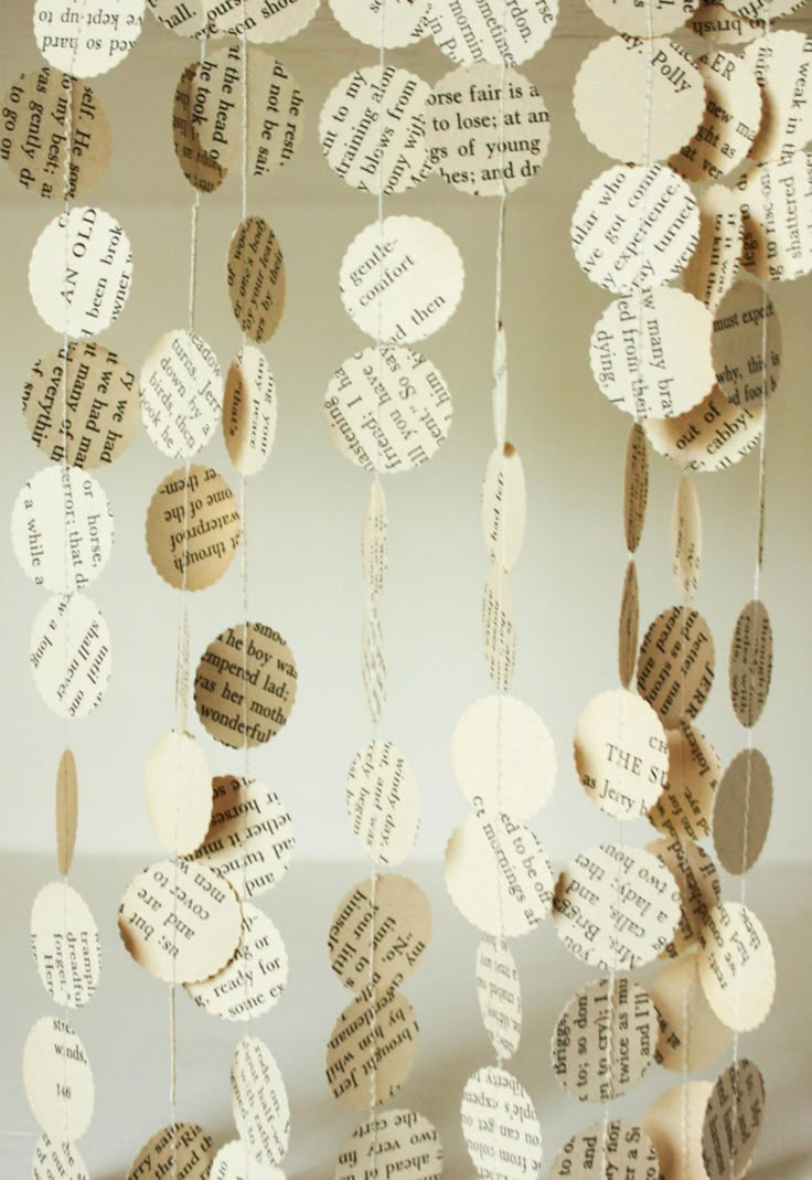 some paper hearts hanging from strings with words on them and string attached to the strings