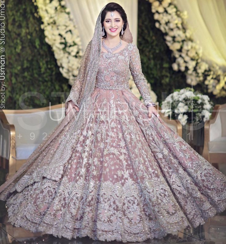 a woman in a wedding dress posing for the camera