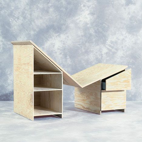 a desk made out of plywood is shown in front of a gray wall and floor