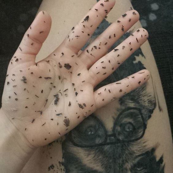 a close up of a person's hand with dirt on it