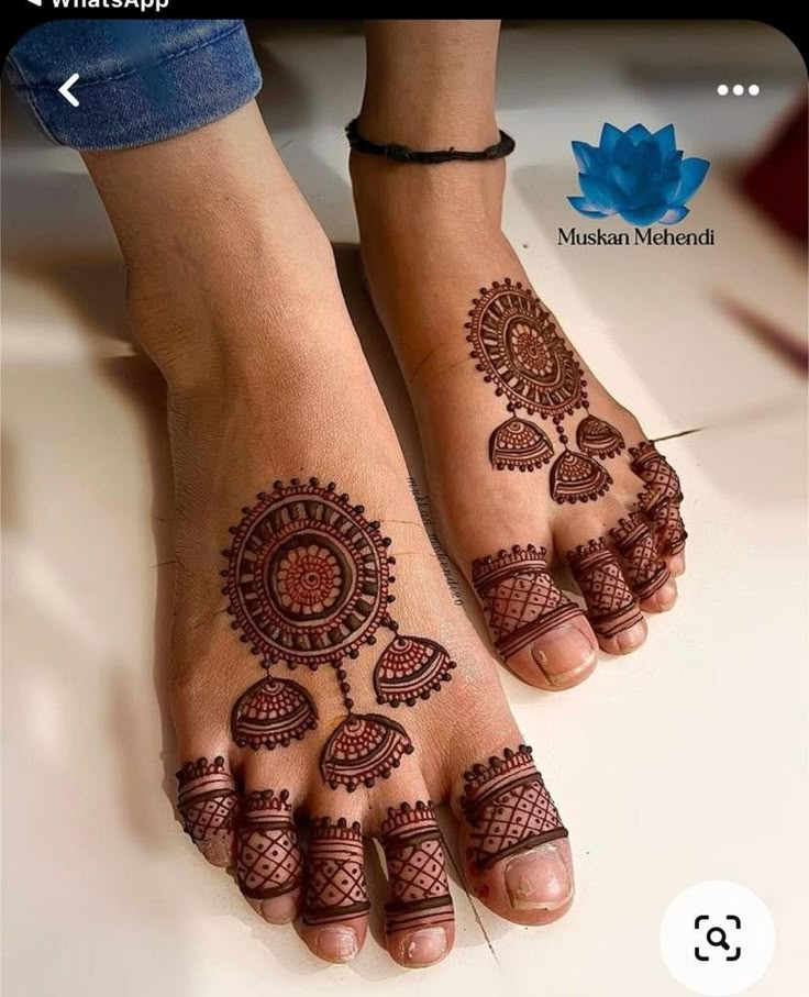 two feet with henna tattoos on them