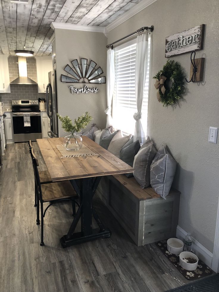 a wooden table sitting in the middle of a kitchen