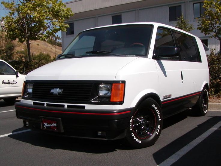 a white van is parked in a parking lot