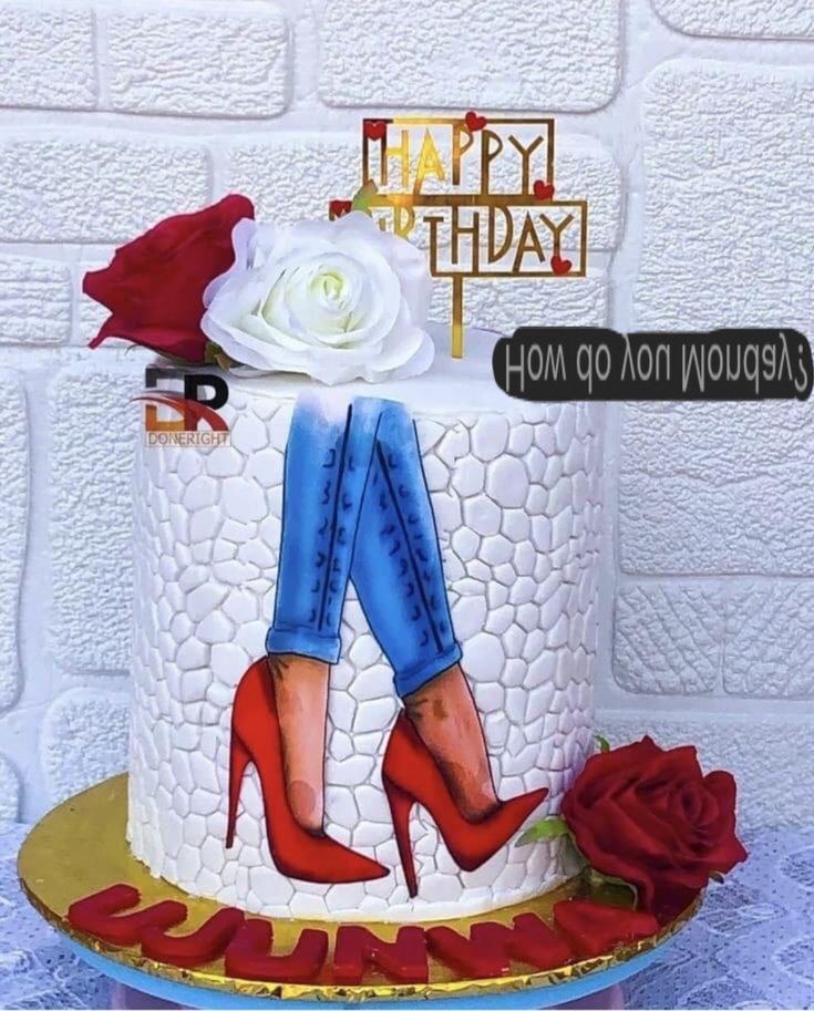 a decorated birthday cake with high heels and roses