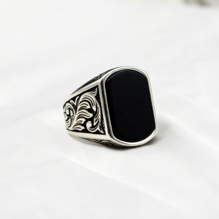 Make a statement of strength and style with this striking black onyx men's ring. Perfect for everyday wear or special occasions, the deep black hue of the onyx stone is set off beautifully by the silver or gold metal band. This elegant and timeless piece is sure to become a staple in any man's accessory collection. Handcrafted with care and attention to detail, this black onyx men's ring is a sophisticated choice for the modern gentleman. Material : 925 Sterling Silver Gemstone    : Onyx Stone C Black Onyx Engagement Ring Men, Black Onyx Ring Men, Onyx Ring Men, Black Onyx Engagement Ring, Ring Men, Black Onyx Ring, Modern Gentleman, Personalized Rings, Metal Band